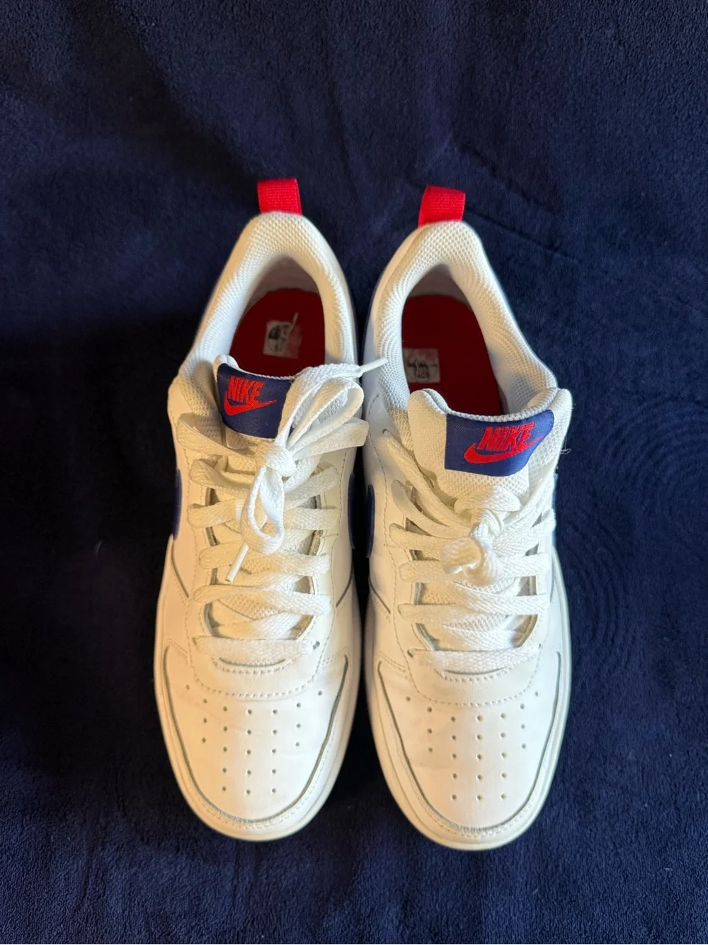 Nike Kids White Sneakers with Blue Swoosh and Red Heel Tab